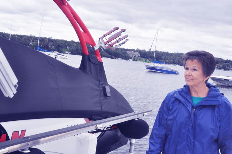 Harbormaster Linda Frame looks over a boat docked on the west end pier to make sure there is no damage