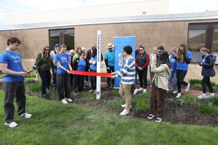Members of the Rotary Club of Lake Geneva install a peace pole at Badger High School (copy)