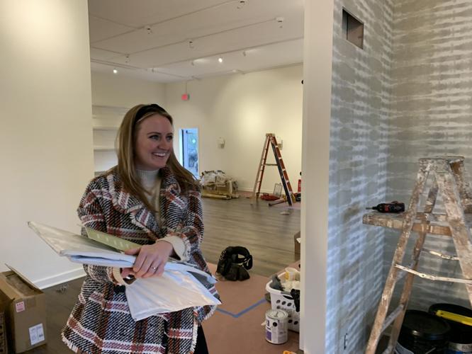 Carly Loobek smiles as she looks over renovation work
