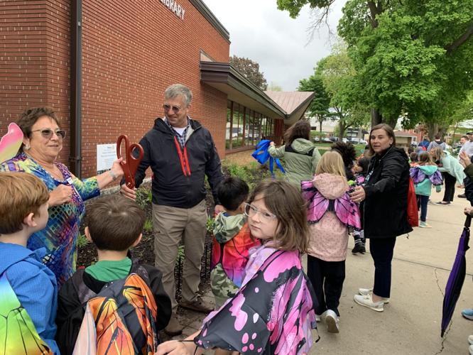 Mayor Todd Krause along with Rotary Club of Lake Geneva members and Central-Denison Elementary School students cut the ribbon for the Monarch Habitat Garden