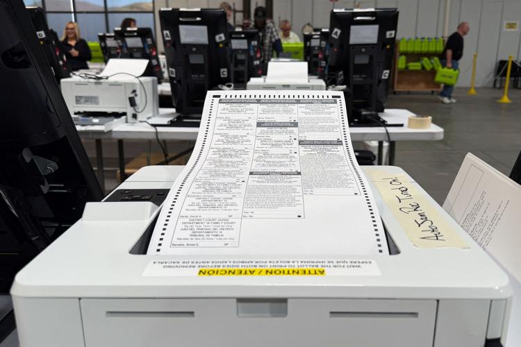 Election workers print sample ballots during mandatory testing of voting machines ahead of the 2026 midterm elections in Reno