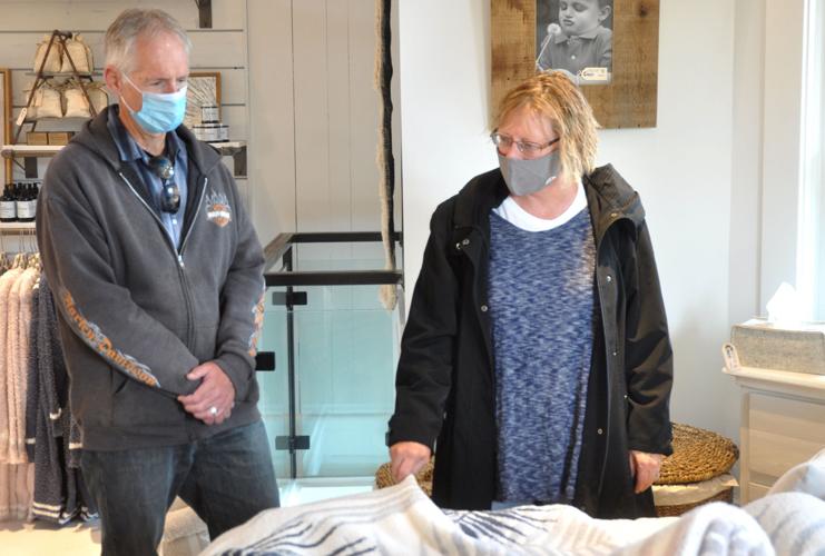 Kurt and Jill Hoffmann of Waterford look over some bedding items at the Brick & Mortar
