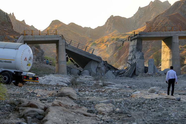 A heavily-damaged bridge which was hit by a US strike is pictured along the road connecting Roudan and Bandar Abbas in southern Iran on July 18, 2026. The United States hit Iran on July 17, with Tehran accusing US forces of striking civilians sites and ...