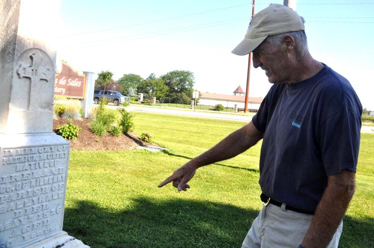 Jerry Hawver, member of the St. Francis de Sales Cemetery Committee, points out