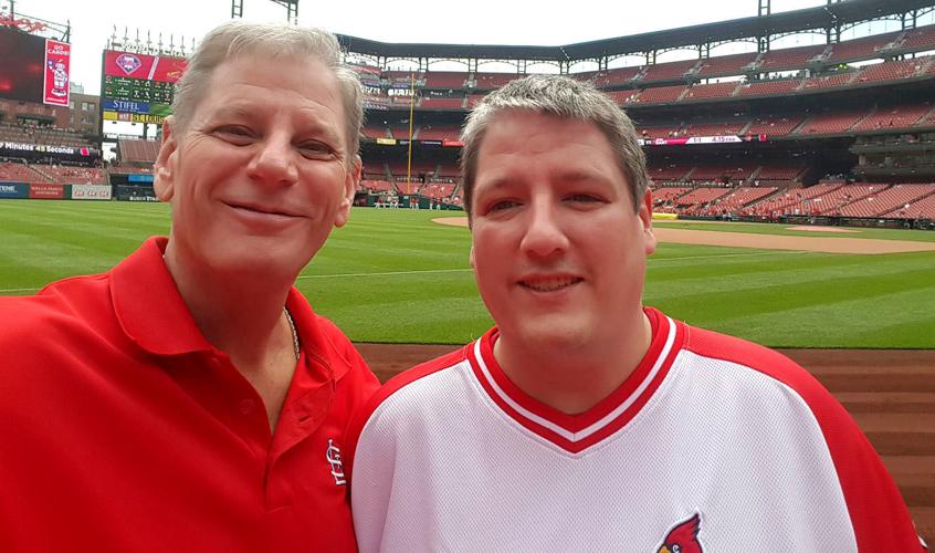 Michael Jackson, left, poses with his son, Andrew Jackson, during a St. Louis Cardinal baseball game