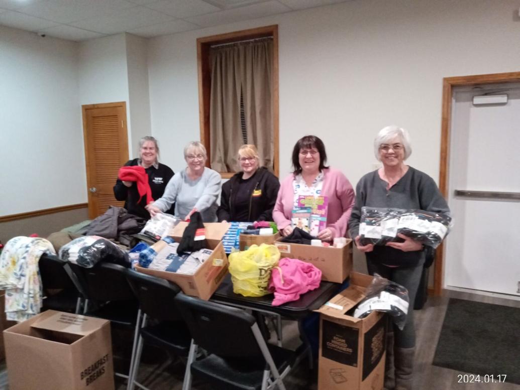 VFW Post 4843 Auxiliary members gather with items donated from recent