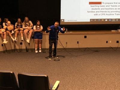 Teacher speaks to students during CPR assembly at Armstrong Jr.-Sr. High School
