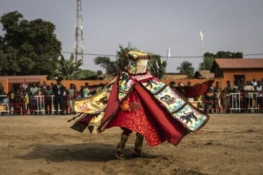 A costumed Egungun figure, revering ancestors, dances during festivities last January in Ouidah