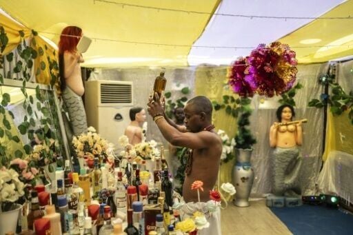 Seen here at last year's Vodun Days a proponent of Voodoo rites makes offerings to aquatic deity Mami Wata