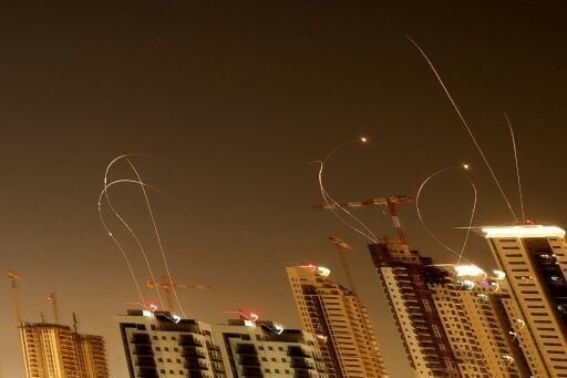 Rocket trails are seen in the sky above the Israeli coastal city of Netanya amid a fresh barrage of Iranian missile attacks on Tuesday