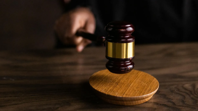 judge-striking-gavel-on-wooden-block.png