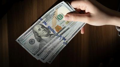 hand-holding-hundred-dollar-bills.jpg