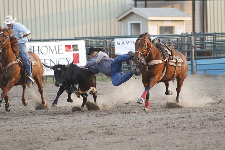 St. Paul’s Grant Turek rushes towards the calf as it is snagged by the rope during the tie down roping event, his time was 10 seconds.
