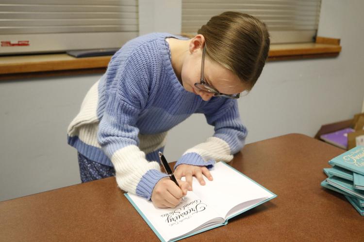 Lucy Martin signs a book