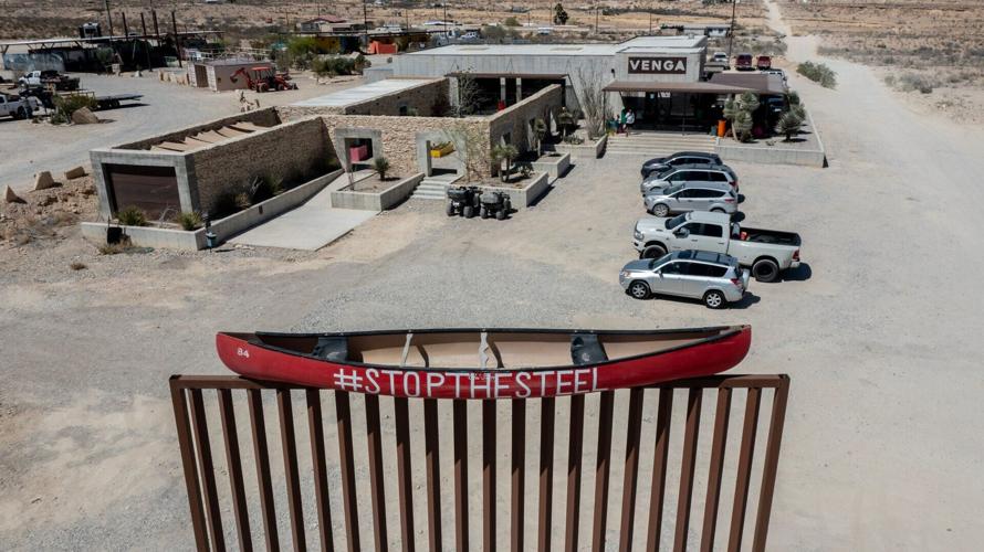 A canoe bearing the hashtag #StopTheSteel sits atop a mock wall representing the border wall outside the Venga Restaurant in Terlingua, Texas, on March 24, 2026. The display is part of a grassroots effort by residents and business owners in the Big Bend re