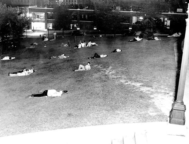 Summer insomniacs find a refuge from the heat on the grassy slopes of Central High Schools hill-top lawn. July 28, 1941