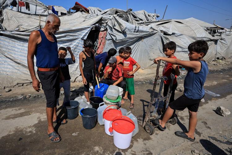 Palestinians shelter at a tent camp in Gaza City