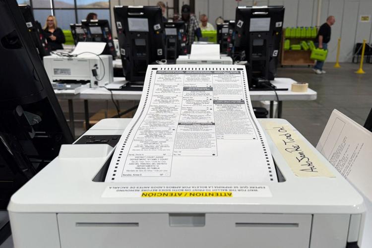 Election workers print sample ballots during mandatory testing of voting machines ahead of the 2026 midterm elections in Reno