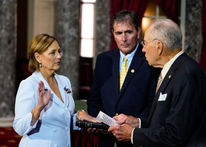 Darline Graham Nordone, left, standing with her husband Larry Nordone, takes part in a ceremonial swearing-in as a U.S. Senator
