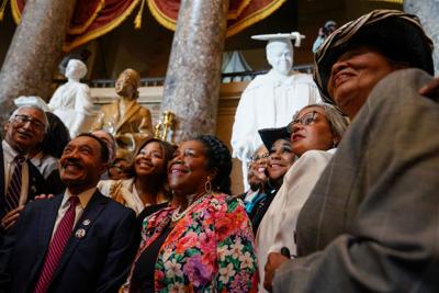 Members of the Congressional Black Caucus pose for photographs in front of the statues of Mary McLeod Bethune and Rosa Parks after Speaker of the House Nancy Pelosi, D-Calif. and congressional leaders hosted a statue dedication and unveiling ceremony in ho
