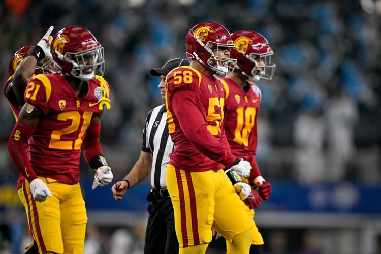 USC Trojans defensive back Latrell McCutchin (21) and defensive end Solomon Tuliaupupu (58) celebrate during the game between the USC Trojans and the Tulane Green Wave in the 2023 Cotton Bowl at AT&T Stadium.
