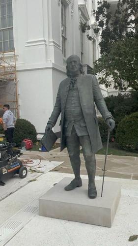 A statue of Ben Franklin in the Rose Garden.
