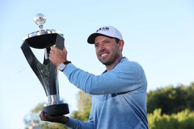 South African golfer Charl Schwartzel celebrates with the trophy during the podium ceremony after winning the LIV Golf Invitational Series event at The Centurion Club in St. Albans, north of London, on Saturday, June 11, 2022.