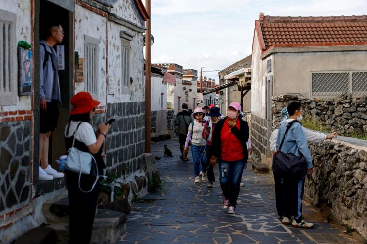 Tourists visit Erkan Historical Village, in Penghu