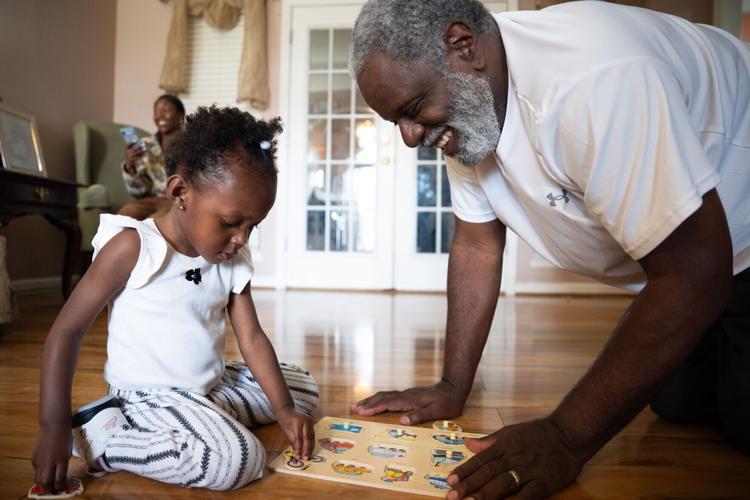 Michael Mays plays with his 2-year-old step-granddaughter, Kana-Leia Murray, at their home in Nashville on Tuesday, March 31, 2026.