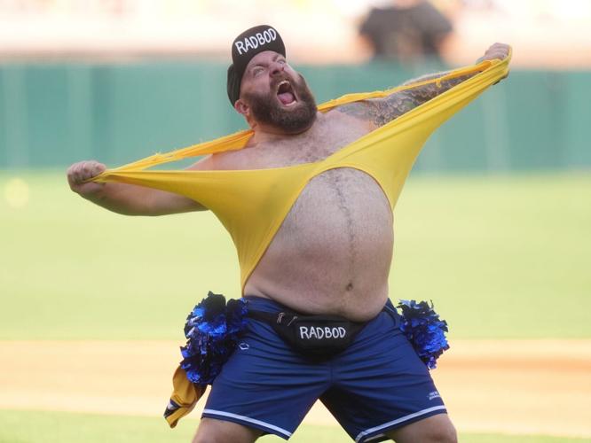 A member of the Man-Nanas, the Savannah Bananas’ Dad Bod Cheer Squad, welcomes the crowd with a t-shirt tear before the start of
