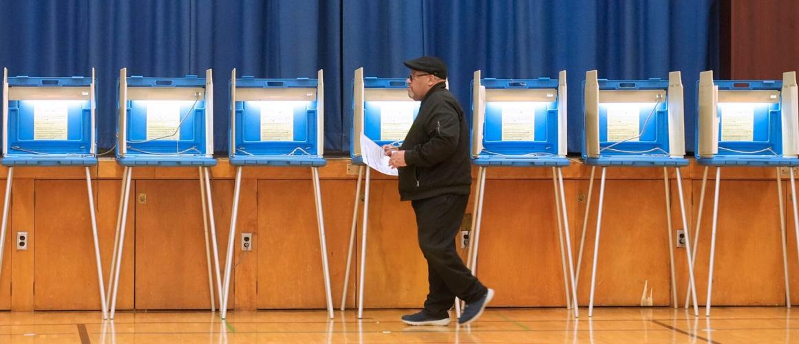 Michael Simmons, 65, carries his ballot after voting at Ninety-Fifth Street School at 3707 N. 94th St. in Milwaukee, Wisconsin (copy)