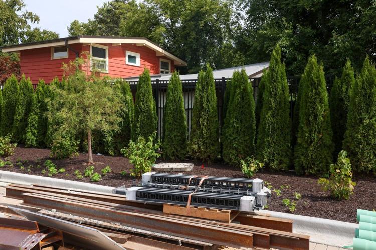 Tall shrubs serve as a buffer between the stadium and nearby homes outside of Northwestern University’ s new Ryan Field on Sept. 14, 2026, in Evanston, Ill..