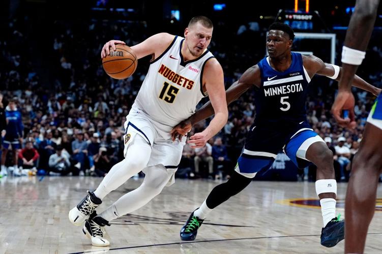 Denver Nuggets center Nikola Jokic (15) drives against Minnesota Timberwolves guard Anthony Edwards (5) during a game in Denver on Mar 12, 2025.
