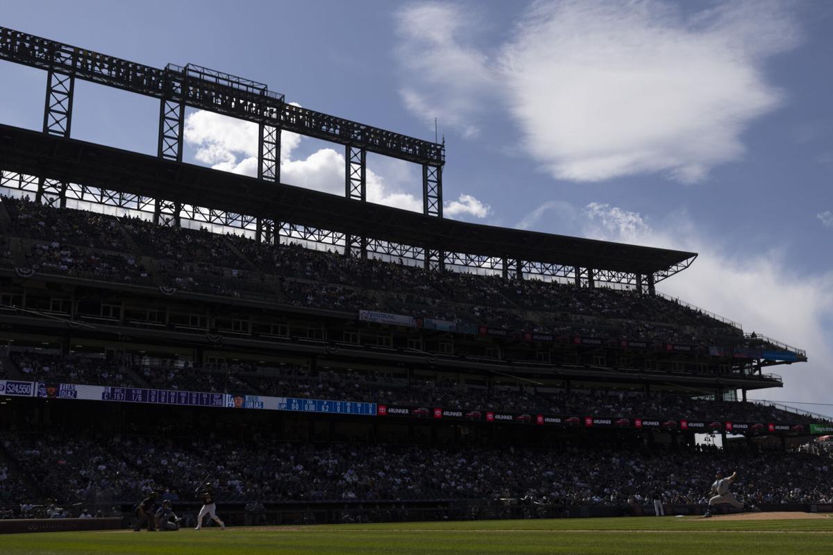 Starting pitcher Julio Urias #7 of the Los Angeles Dodgers delivers to home plate against Elias Diaz #35 of the Colorado Rockies during the seventh inning at Coors Field on April 4, 2021 in Denver, Colorado.