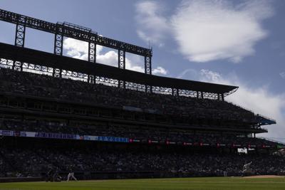 Starting pitcher Julio Urias #7 of the Los Angeles Dodgers delivers to home plate against Elias Diaz #35 of the Colorado Rockies during the seventh inning at Coors Field on April 4, 2021 in Denver, Colorado.