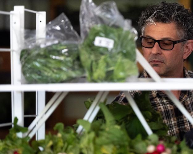 Seth Alexander shops for produce May 9, 2026 at the Farmers Market in downtown Iowa City, Iowa.