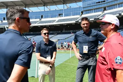 ESPN Mike Monaco talks to a coach during the CWS