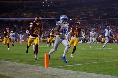 Nov 9, 2025; Landover, Maryland, USA; Detroit Lions running back Jahmyr Gibbs (0) runs in for a touchdown past Washington Commanders safety Quan Martin (20) and cornerback Jonathan Jones (31) during the fourth quarter at Northwest Stadium. Mandatory Credit