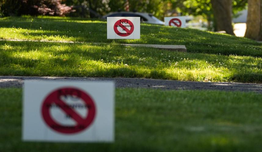 Signs seen in a downtown Mason yards against data centers, Tuesday, June 2, 2026.