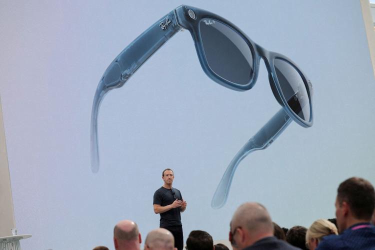 FILE PHOTO: A pair of Ray-Ban smart glasses appear on screen at an event in California