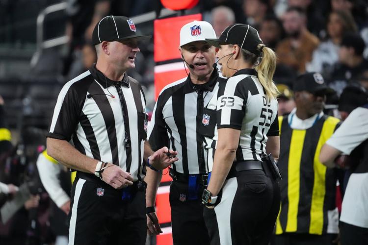 NFL officials talk between plays during the second half of a game between the Las Vegas Raiders and the Dallas Cowboys on Nov. 17, 2025, at Allegiant Stadium in Paradise, Nevada.