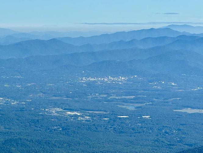 Asheville, seen here from 12 miles to the southwest, is surrounded by lush woodlands that power the region's tourism economy.