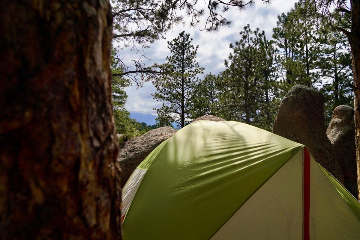 The view of the mountains above a tent at the guys' campsite near Buffalo Creek Campground near Bailey, Colorado on July 16, 2024.