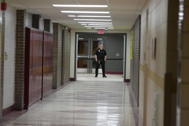 A security guard stands at one entrance of the school to the gym at Greece Athena High School in Rochester, New York, on Feb. 2, 2026.