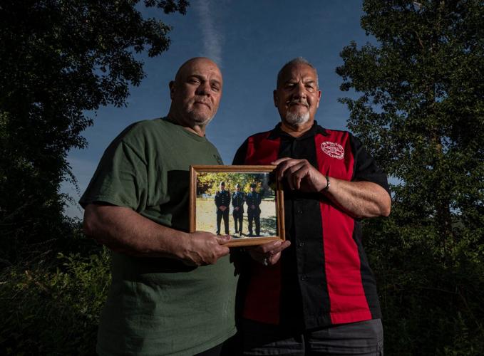 Robert and Al Bucca, photographed July 8, 2026, hold a photo of themselves with their brother Ron, an FDNY Fire Marshal who died in the Sept. 11 attacks on the World Trade Center. All three brothers served in United States Army. Ron Bucca was a resident of