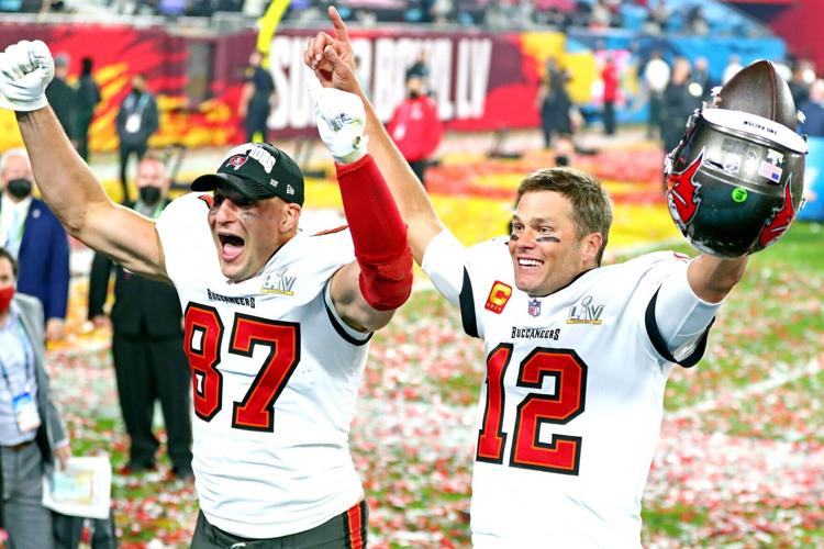 Feb 7, 2021; Tampa, FL, USA;  Tampa Bay Buccaneers quarterback Tom Brady (12) and tight end Rob Gronkowski (87) celebrate after beating the Kansas City Chiefs in Super Bowl LV at Raymond James Stadium.  Mandatory Credit: Mark J. Rebilas-USA TODAY Sports