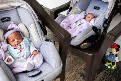 Three-week-old twins Jaliyah and Janiyah, born July 1 to two Detroit EMTs rest in their carseats on the porch as their mother Jessica Johnson, 31, speaks to media about the EMTs that delivered her babies in Detroit on Monday, July 21, 2025.