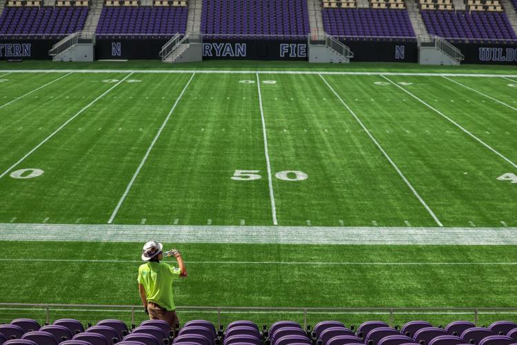 Construction worker Vincent Carbone takes a drink of water while working on Northwestern University’ s nearly finished Ryan Field on Sept. 14, 2026, in Evanston, Ill..