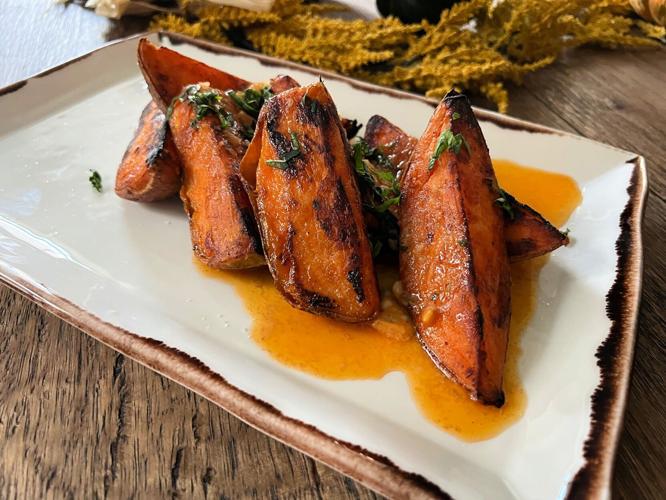 Chef Cory Hughews gives roasted sweet potatoes a spicy kick with a compound butter crafted with red curry, lime and garlic.