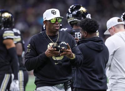 Dec 28, 2024; San Antonio, TX, USA; Colorado Buffaloes head coach Deion Sanders walks on the field between plays during the first quarter against the Brigham Young Cougars at Alamodome. Mandatory Credit: Troy Taormina-Imagn Images